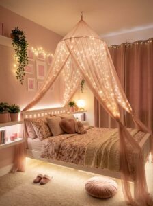 Cozy magical bedroom aesthetic showing a sheer pink tulle bed canopy netting hung with warm fairy curtain string lights above floral bedding and floor pouf cushions.