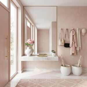 A modern minimalist hallway with a floor to ceiling gold mirror reflecting a blush pink door and marble shelf