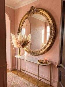 A beautifully decorated apartment foyer featuring cozy entryway ideas with soft blush pink walls, an elegant console table, and warm lighting to create a welcoming first impression.