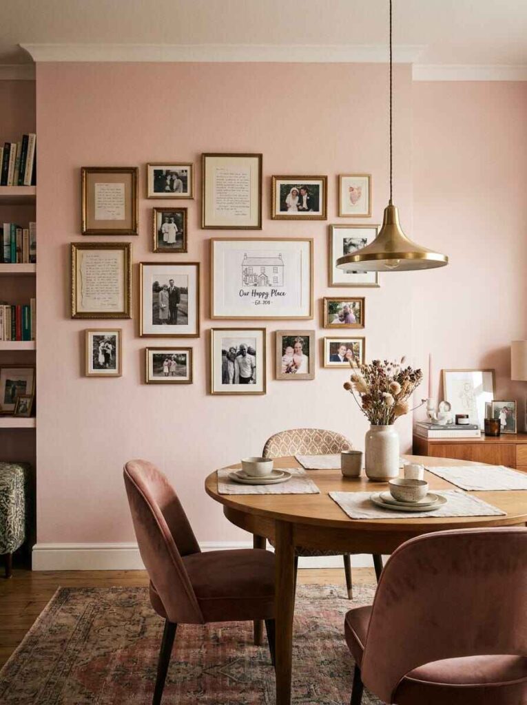 Personalized dining room gallery wall with framed family photographs and typography prints above a round wood dining table.